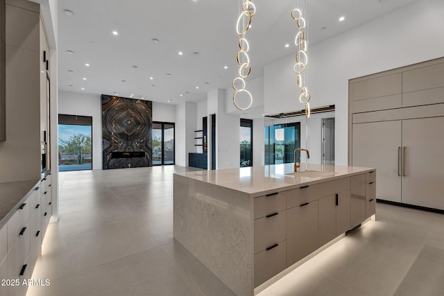 10354 E Celestial Dr, Scottsdale, AZ 85262 - kitchen featuring modern cabinets, a sink, a large island with sink, light stone counters, and open floor plan