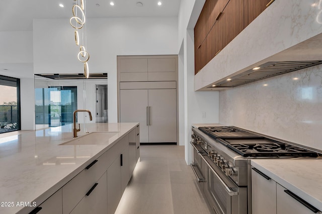 10354 E Celestial Dr, Scottsdale, AZ 85262 - kitchen featuring a sink, high end appliances, exhaust hood, modern cabinets, and light stone counters