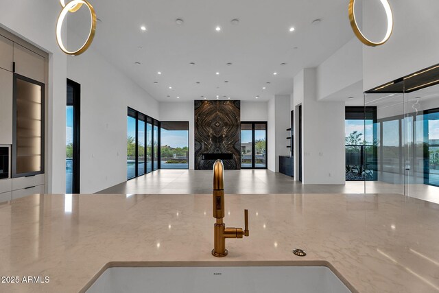 10354 E Celestial Dr, Scottsdale, AZ 85262 - kitchen featuring open floor plan, recessed lighting, light stone countertops, a sink, and healthy amount of natural light