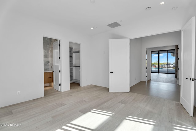 10354 E Celestial Dr, Scottsdale, AZ 85262 - unfurnished bedroom with light wood-style flooring, a walk in closet, ensuite bathroom, and recessed lighting
