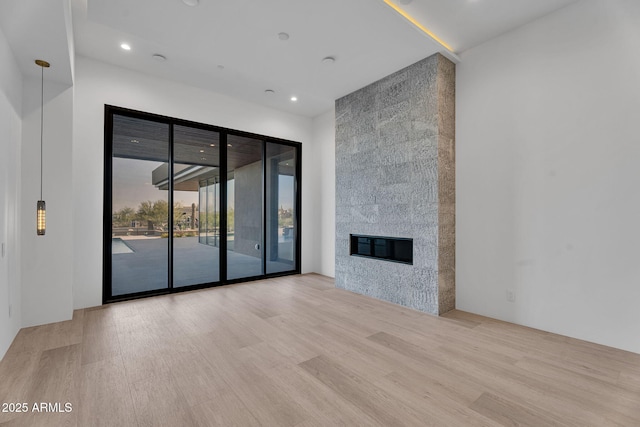 10354 E Celestial Dr, Scottsdale, AZ 85262 - unfurnished living room featuring wood finished floors, a fireplace, and recessed lighting
