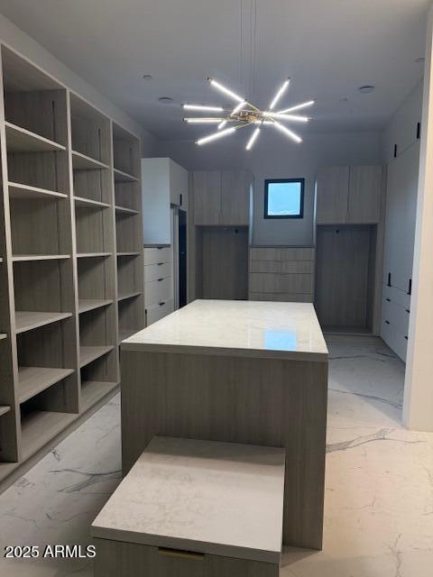 10354 E Celestial Dr, Scottsdale, AZ 85262 - kitchen featuring light marble finish flooring, a center island, modern cabinets, and light countertops