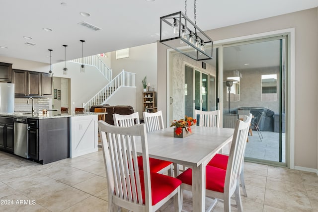 tiled dining space featuring sink