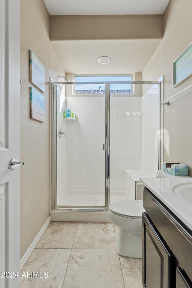 bathroom featuring toilet, tile patterned floors, vanity, and walk in shower