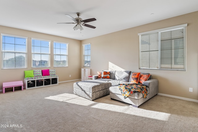 carpeted living room featuring ceiling fan