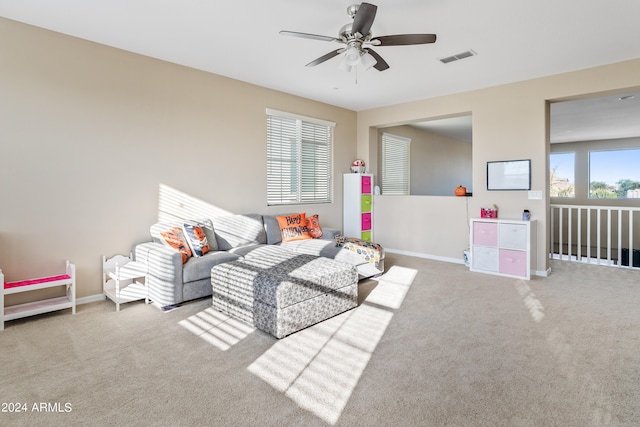 living room featuring carpet floors and ceiling fan