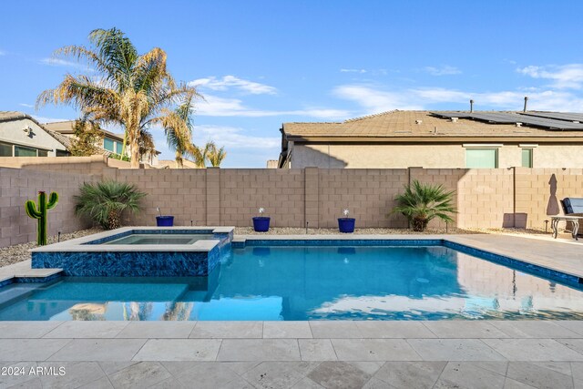 view of pool featuring an in ground hot tub