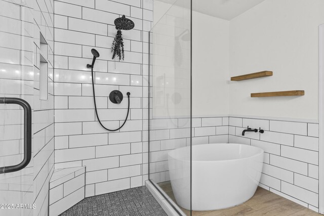 1225 N 36th St Unit 1015, Phoenix, AZ 85008 - full bathroom with tile walls, tiled shower, a freestanding bath, wood finished floors, and a wainscoted wall