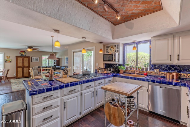 7302 E Rose Ln, Scottsdale, AZ 85250 - kitchen with appliances with stainless steel finishes, a sink, and white cabinetry