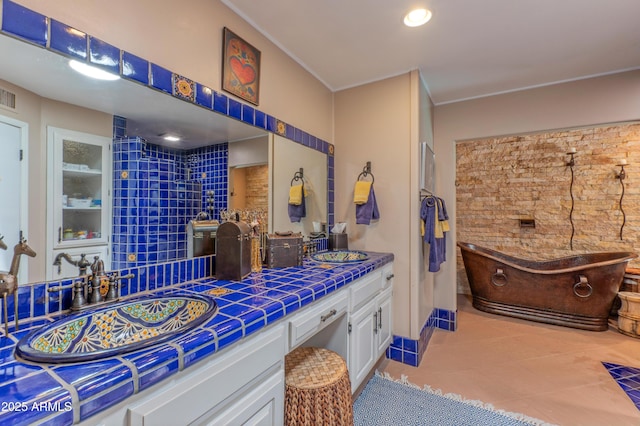 7302 E Rose Ln, Scottsdale, AZ 85250 - bathroom featuring double vanity, a freestanding tub, and tile patterned floors