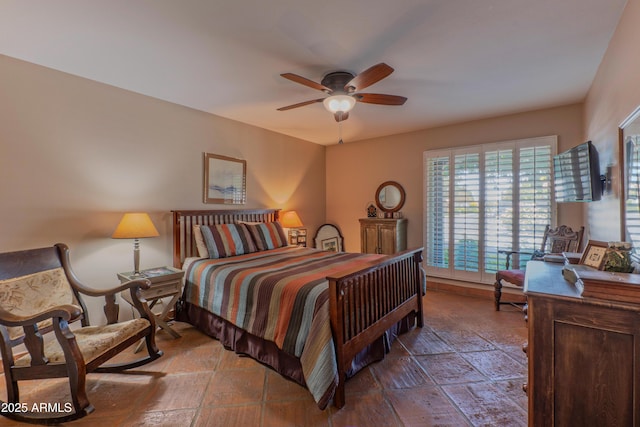 7302 E Rose Ln, Scottsdale, AZ 85250 - bedroom featuring stone tile floors and a ceiling fan