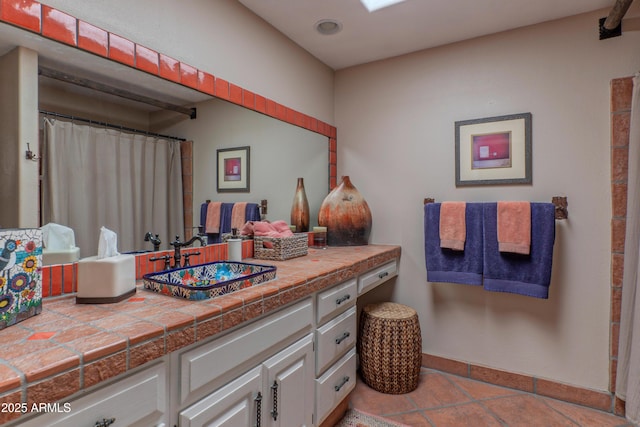 7302 E Rose Ln, Scottsdale, AZ 85250 - full bath featuring vanity, baseboards, and tile patterned floors