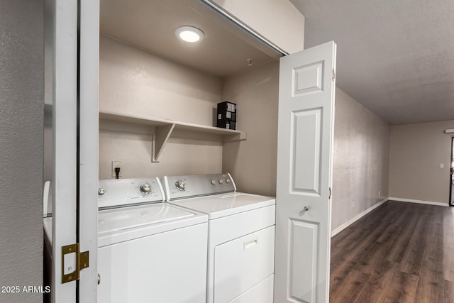 laundry area with laundry area, washer and dryer, dark wood-type flooring, and baseboards