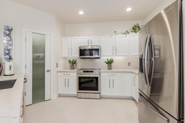 kitchen with white cabinetry, sink, and appliances with stainless steel finishes