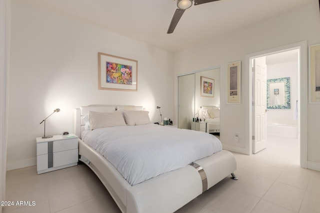 tiled bedroom with ceiling fan and a closet