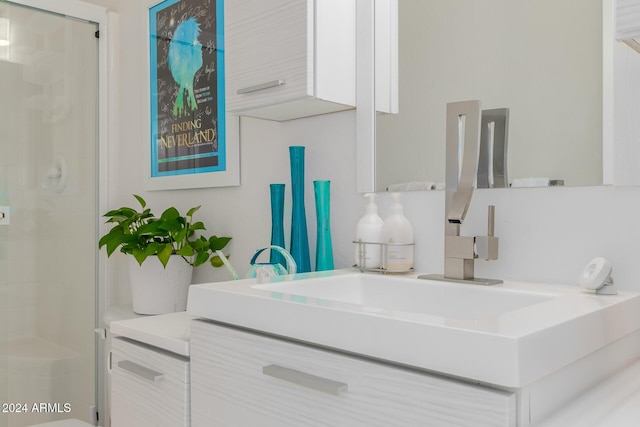 bathroom featuring vanity and a shower with door