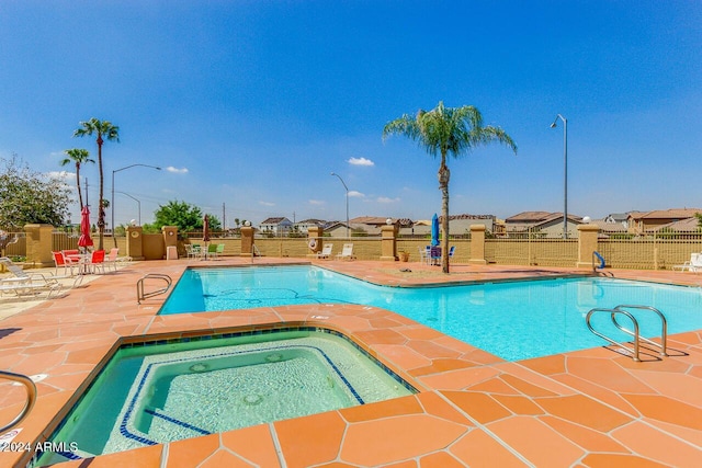 view of pool featuring a patio area and a community hot tub