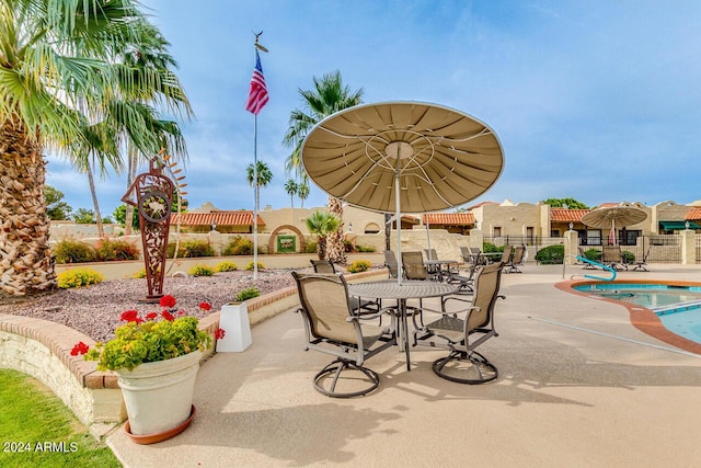 view of patio / terrace with a fenced in pool