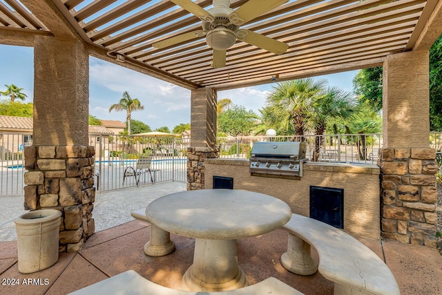 view of patio with area for grilling, ceiling fan, and a community pool