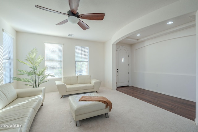 living room featuring arched walkways, recessed lighting, wood finished floors, a ceiling fan, and visible vents