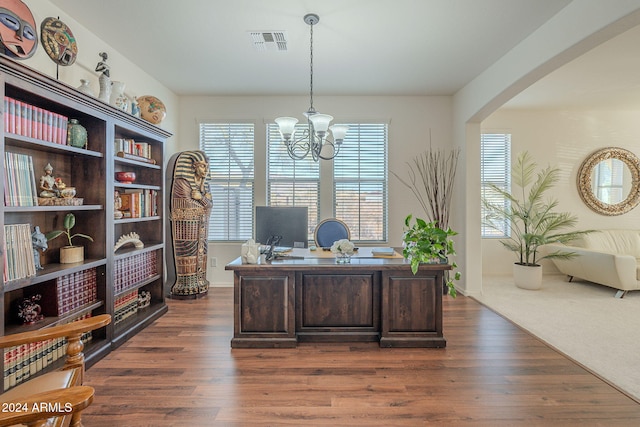 office space featuring dark hardwood / wood-style floors and an inviting chandelier