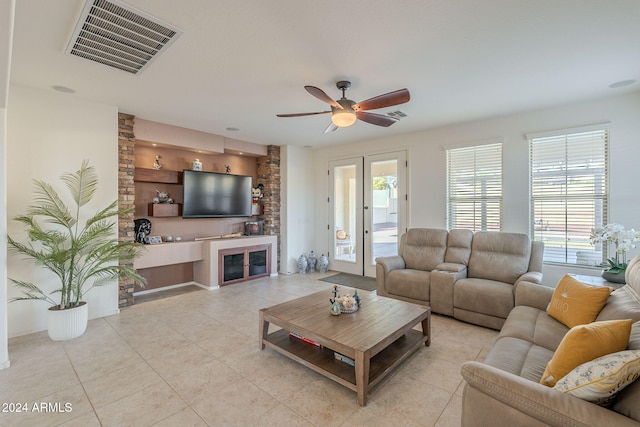 living room with ceiling fan, french doors, and light tile patterned floors