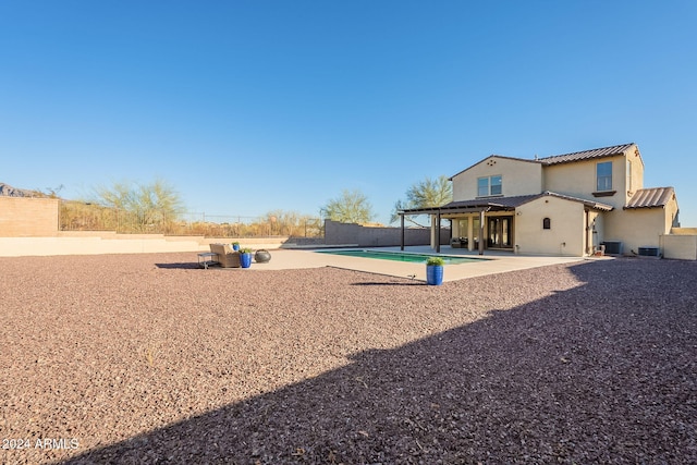 exterior space featuring cooling unit, a fenced backyard, stucco siding, a pergola, and a patio area