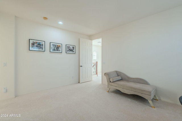 living area with recessed lighting and light colored carpet