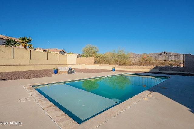 view of pool with a mountain view and a patio