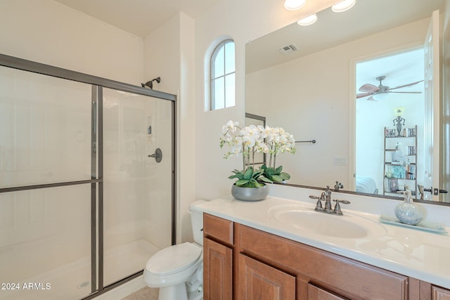 bathroom with ceiling fan, toilet, walk in shower, and vanity