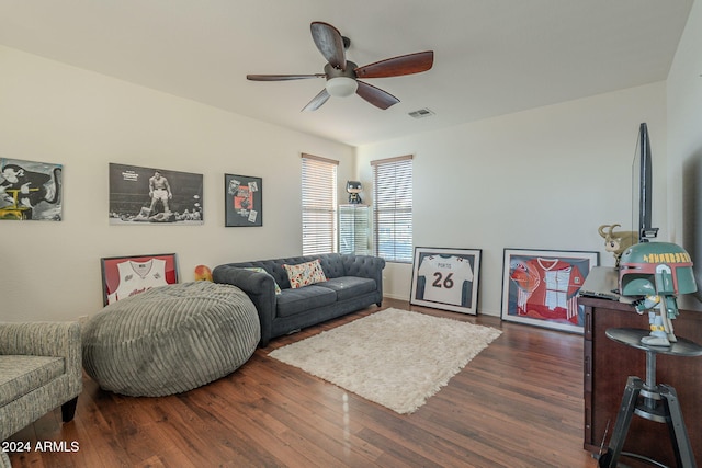 living room featuring dark hardwood / wood-style flooring and ceiling fan