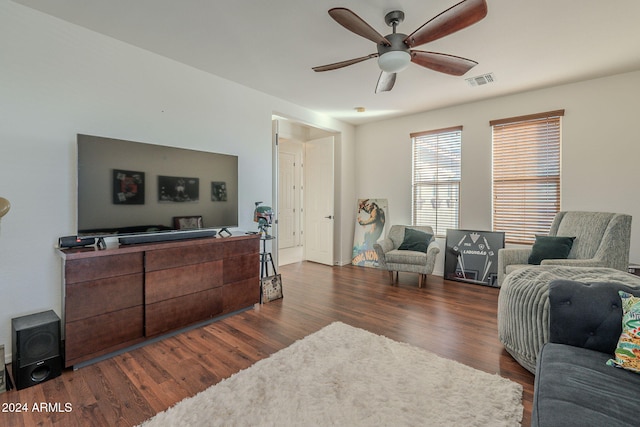 living area with a ceiling fan, dark wood-style flooring, and visible vents