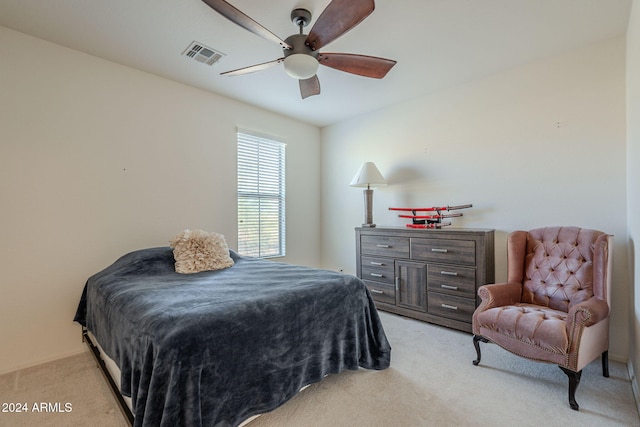 bedroom featuring ceiling fan, visible vents, and light colored carpet