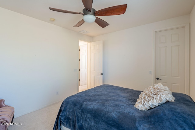 carpeted bedroom featuring ceiling fan and visible vents