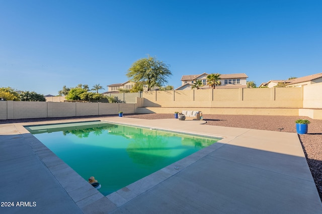 view of swimming pool featuring a fenced in pool, a patio area, and a fenced backyard