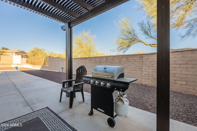 view of patio featuring area for grilling, a fenced backyard, and a pergola