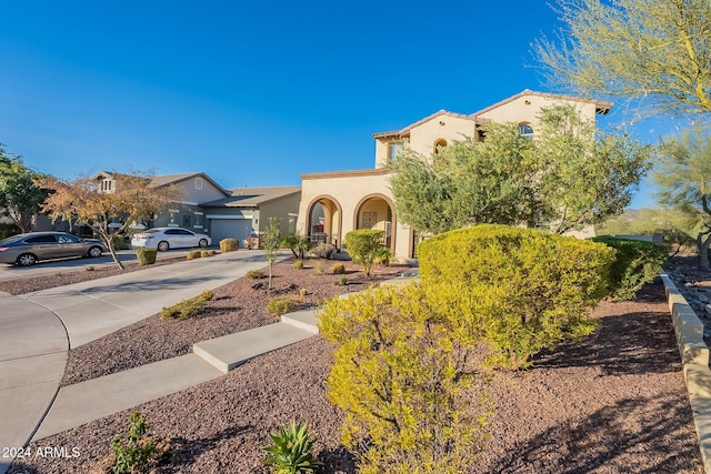 mediterranean / spanish-style house with driveway and stucco siding