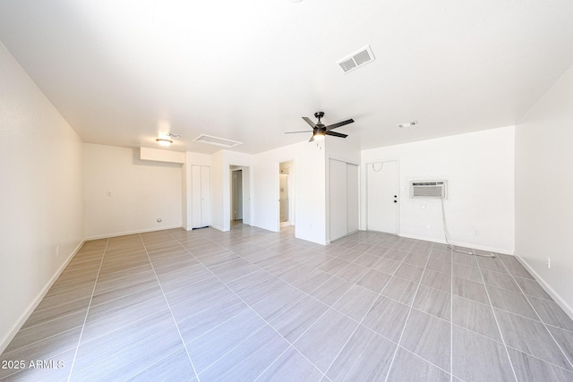 4528 W Butler Dr, Glendale, AZ 85302 - unfurnished living room with ceiling fan, a wall mounted air conditioner, baseboards, and light tile patterned floors