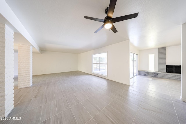 4528 W Butler Dr, Glendale, AZ 85302 - unfurnished living room featuring ceiling fan, a fireplace, and baseboards
