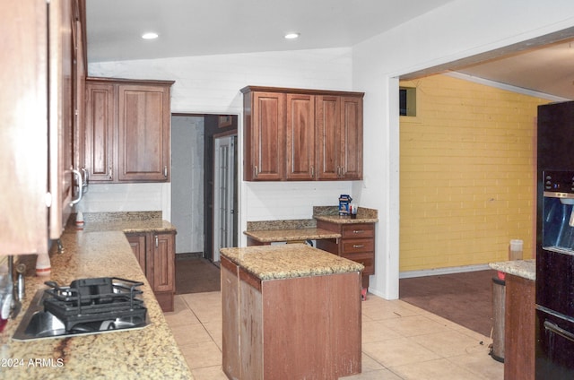 655 W Caroline St, Coolidge, AZ 85128 - kitchen featuring light stone countertops, a kitchen island, lofted ceiling, and gas cooktop