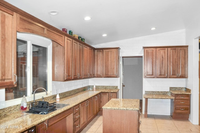 655 W Caroline St, Coolidge, AZ 85128 - kitchen featuring sink, light stone counters, light tile patterned flooring, vaulted ceiling, and a kitchen island