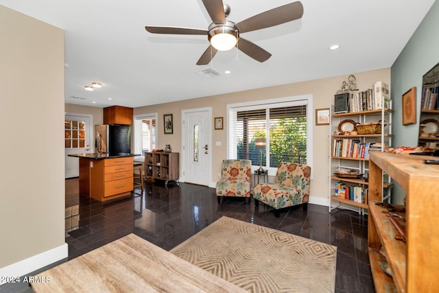 living room featuring dark wood-type flooring, plenty of natural light, and ceiling fan