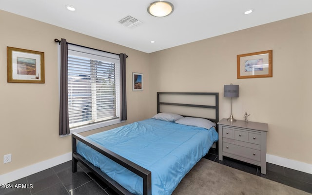 bedroom with dark tile patterned floors