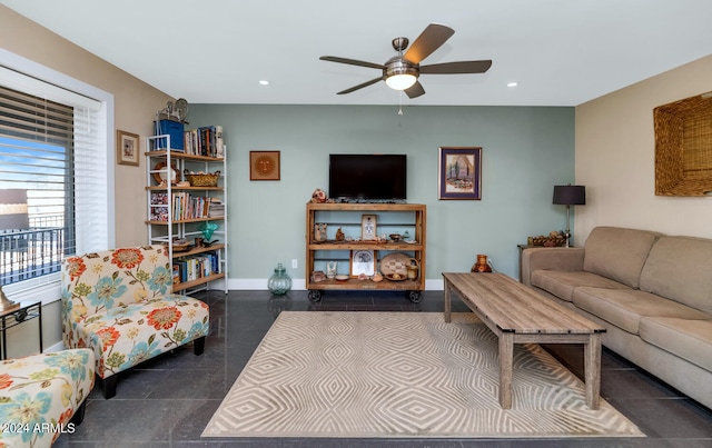 living room with dark tile patterned flooring and ceiling fan