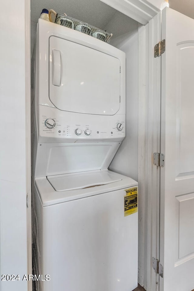 laundry area with stacked washer / drying machine