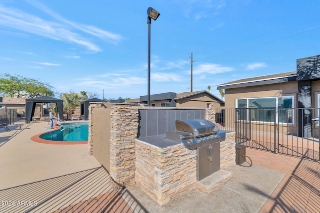 view of pool with a gazebo, area for grilling, and a patio