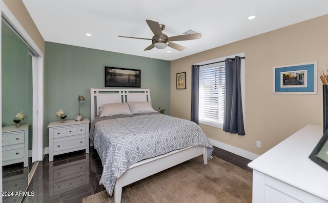 bedroom featuring dark hardwood / wood-style flooring, a closet, and ceiling fan