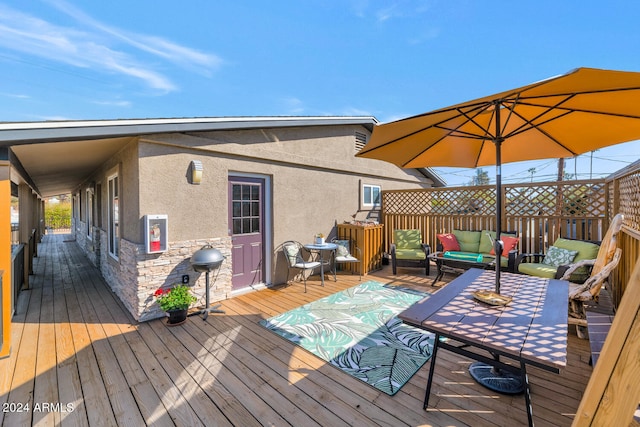 wooden terrace with outdoor lounge area