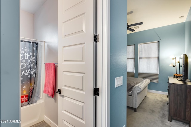 bathroom featuring ceiling fan, vanity, and shower / tub combo