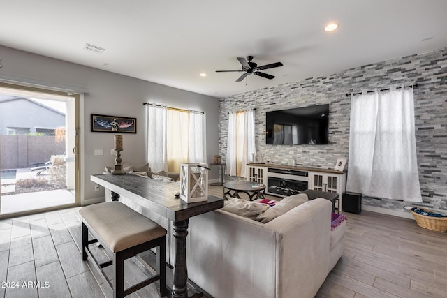 living room with light hardwood / wood-style floors and ceiling fan